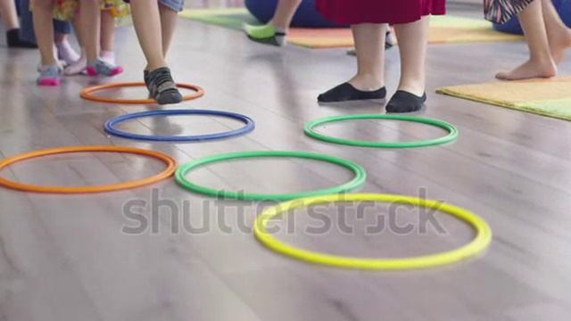 stock-footage-small-nursery-school-children-with-female-teacher-on-floor-indoors-in-classroom-doing- смотреть онлайн