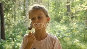 Kid Licking Ice-Cream. Charming Child Eats Ice Cream Outside. Little girl licking ice-cream. | S...
