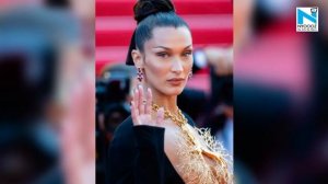 Bella Hadid sports statement lung necklace with risqué dress