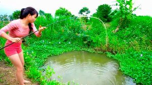 Рыбалка Красивая Девушка ловит большую рыбу на поплавочную удочку в заросшем водоеме