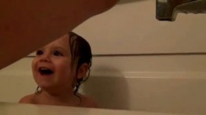 The child bathing in a bath!