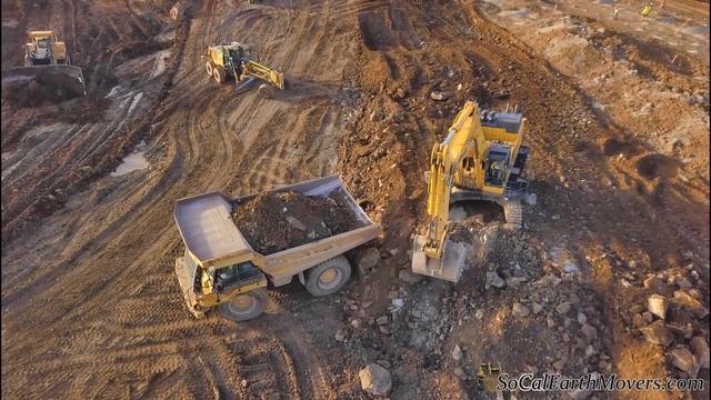 Komatsu PC1250 Excavators loading Cat 777F Haul Trucks on rocky residential project смотреть онлайн