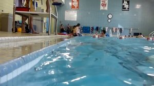 3yo William relaxing next to the wall in the pool