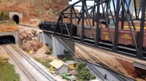 Union Pacific Big Boy No.4014 climbing up a steep grade over a bridge and through a tunnel