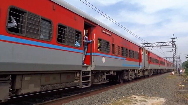 Newly painted speedy EMU local train parallel crossing with Viswabharati fast passenger смотреть онлайн