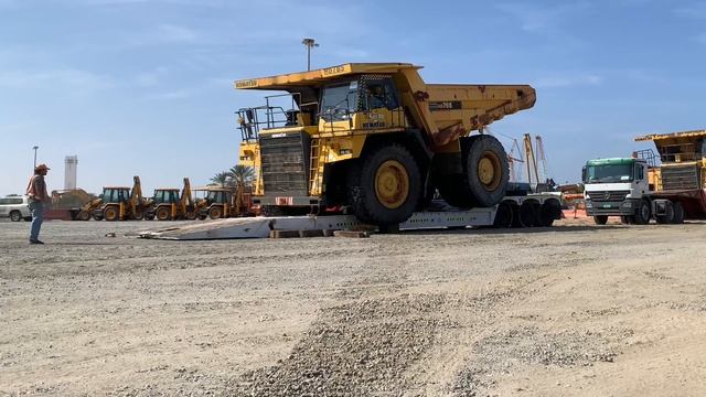 Komatsu  HD 785 Rock Truck Transport And Offload Over Size Machine. Heavy Equipment Mining Quarry.