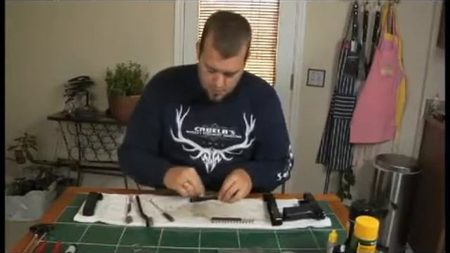 Brushing the Barrel of a Sig Sauer 226 9mm Gun смотреть онлайн