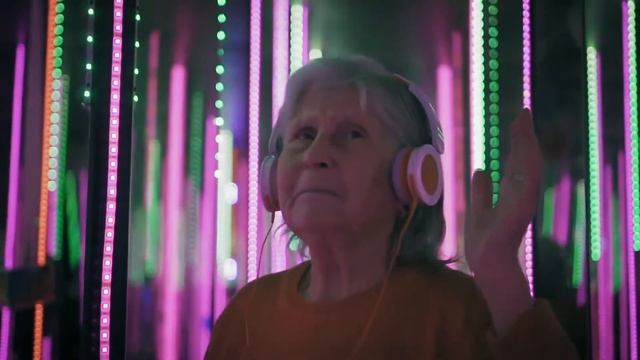 hipster aged woman in headphones is dancing in colorful neon lights смотреть онлайн