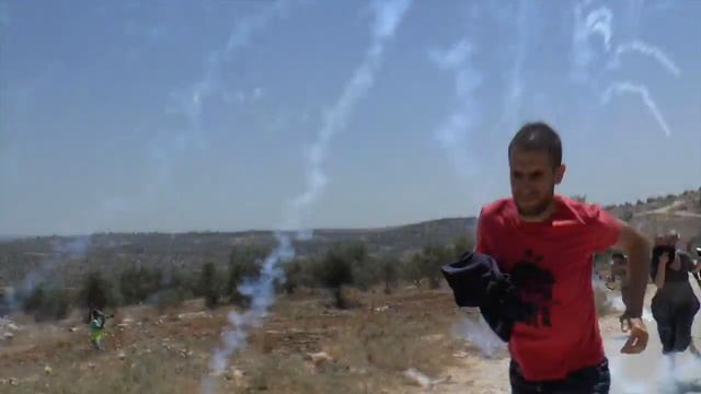 Tear gas grenades during the protest against the separation wall in Bil'in, West Bank, 10 July 2015 смотреть онлайн