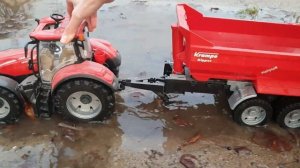 Трактор помогает маленьким машинкам и перевозит их через глубокую лужу