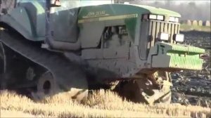 Гусеничный Трактор Джон Дир в грязи пашет на болоте с плугом   Трактора в грязи