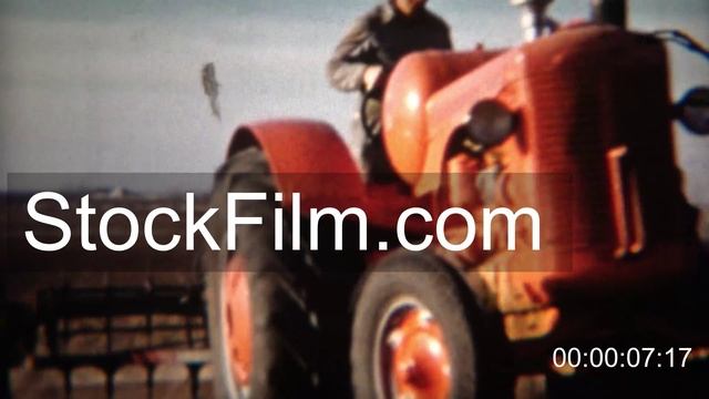 1951: Red tractor plowing farm fields for early spring plant. смотреть онлайн
