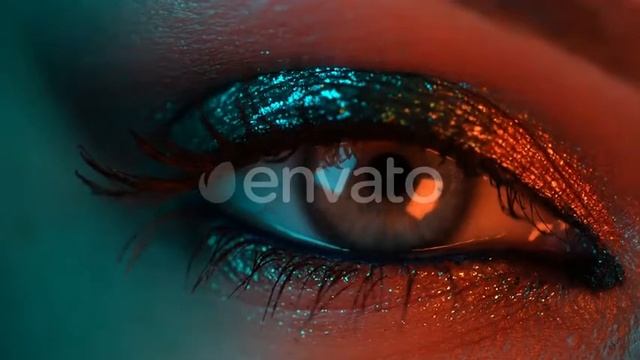 Extreme Close Up Of Human Eye Iris Under Neon Light. Female With Beautiful Makeup, Glitter Shado...