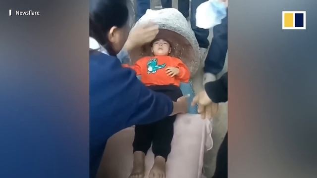 Firefighters Free Chinese Toddler Stuck Upside Down In A Stone Mill While Doing Headstand