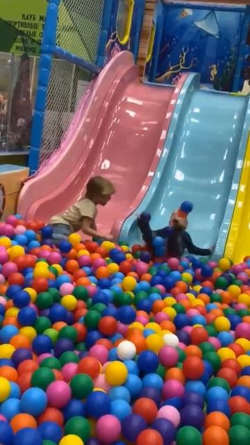 Дети играют на детской площадке. Children Play On The Playground. In Pla