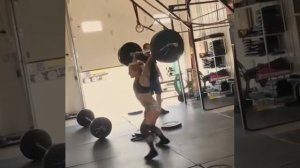 девушка поднимает штангу