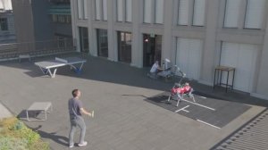 Робособака играет в бадминтон с человеком