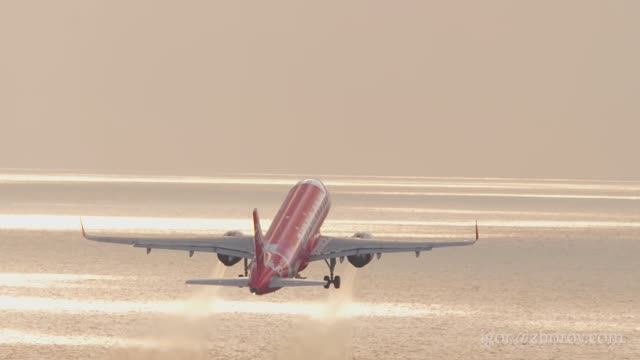 Эйрбас А320neo авиакомпании AirAsia взлетает в закатное небо, аэропорт Пхукет.