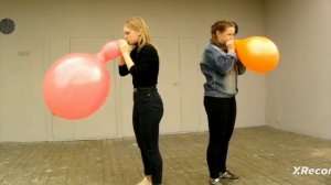 Katie and Ann blow balloons