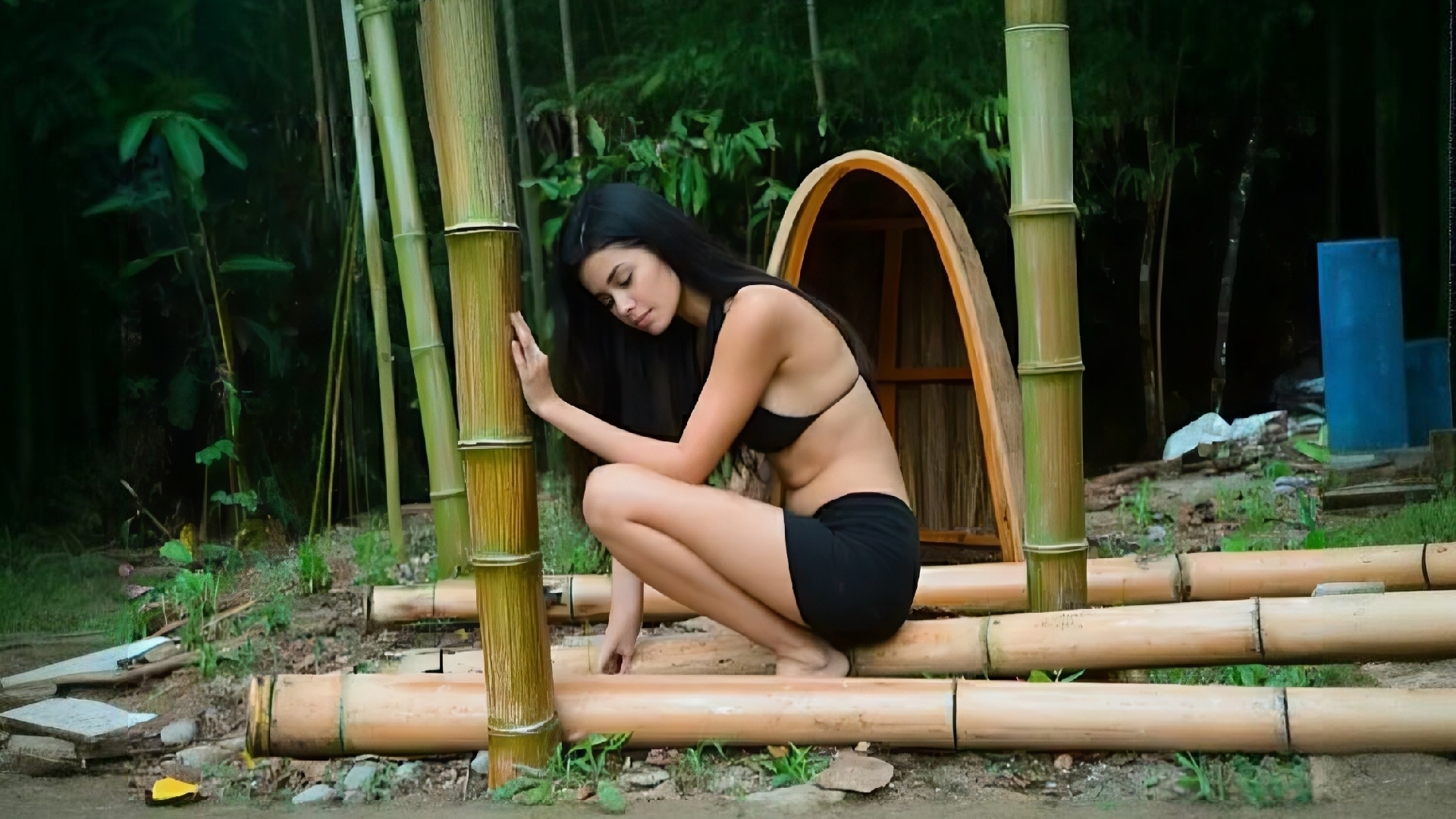 Молодая девушка строит простенькую хижину в джунглях своими руками. Бушкрафт