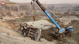 The truck fell down. The crane used its power to straighten it.