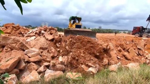 Awesome Mighty Bulldozer Strong Power Filling Large Stones Along The Fence to Protect Flood