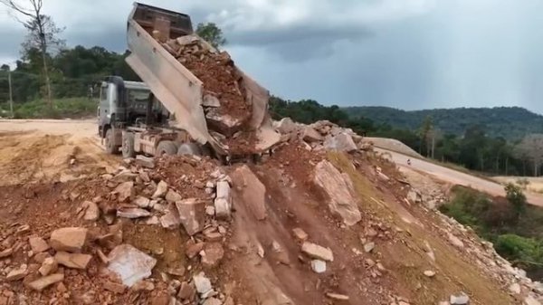 Dump Truck Dumping Stone on Extreme Slope — Mountain Road Building