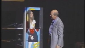 Funny Motivational Speaker Billy Riggs cutting an Audience Member in Thirds