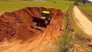 Экскаватор-погрузчик JCB 4CX, работающий с передней оболочкой