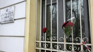 Люди несут цветы к зданию посольства Ирана в Москве