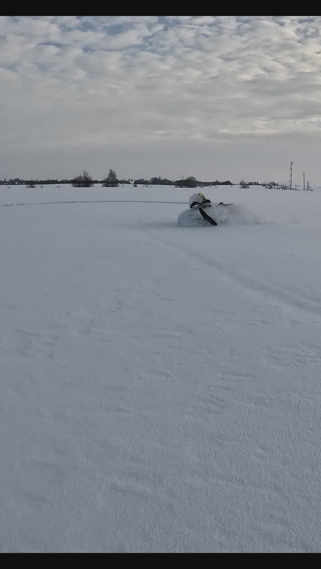 В глубоком снегу.