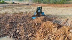 Dump Trucks Unloading Rocks for Road Construction _ Heavy Equipment Working in Muddy Canal Road