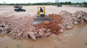 Strong Bulldozer Pushing Rock Drop Into Water Vs Dump Truck Dumping Rock, Land Filling Construction