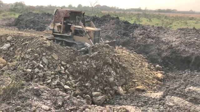 Hard Work!! Bulldozer Push Stone Fill The Road With Dump Truck Dumping Stones