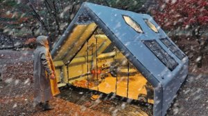 Зимний снежный кемпинг с дровяной печью в надувной палатке.