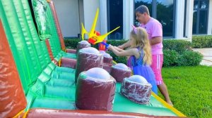 Nastya plays with her dad outside with new toys