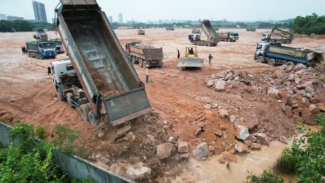 The Extremely Land Filling Heavy Equipment Work- Bulldozer Pushing Rocks vs Dump Truck Dumping Rocks
