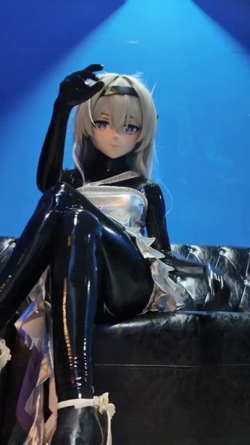 Latex Kigurumi Doll posing on sofa.
