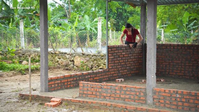 Building Strong Livestock Barn Installing Roof Panels and Finishing Brick Walls for Protection
