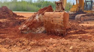 Caterpillar 365C Excavator vs. 80,000+ Pound Boulder Buried Below Grade