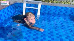 BiBi happily swims with duckling in the pool