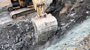 Excavator load rocks in truck