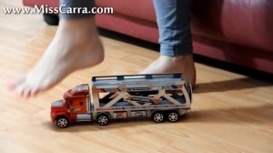 Miss Carra crushes a toy truck barefoot