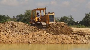 Awesome construction machines big dump truck and bulldozer filling big pond