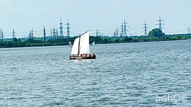 Плывут на парусной лодке.