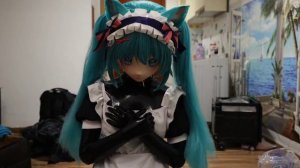Latex Kigurumi Doll tries maid dress with white apron.