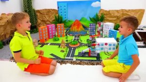 Влад и Ники играют с игрушечными машинками и строят город Matchbox.