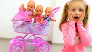 Polina playing with baby carriage for baby dolls