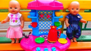 Polina make breakfast on the toy kitchen for her baby dolls