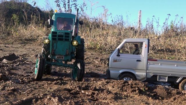 Грузовик вытаскивает RC трактор из грязи